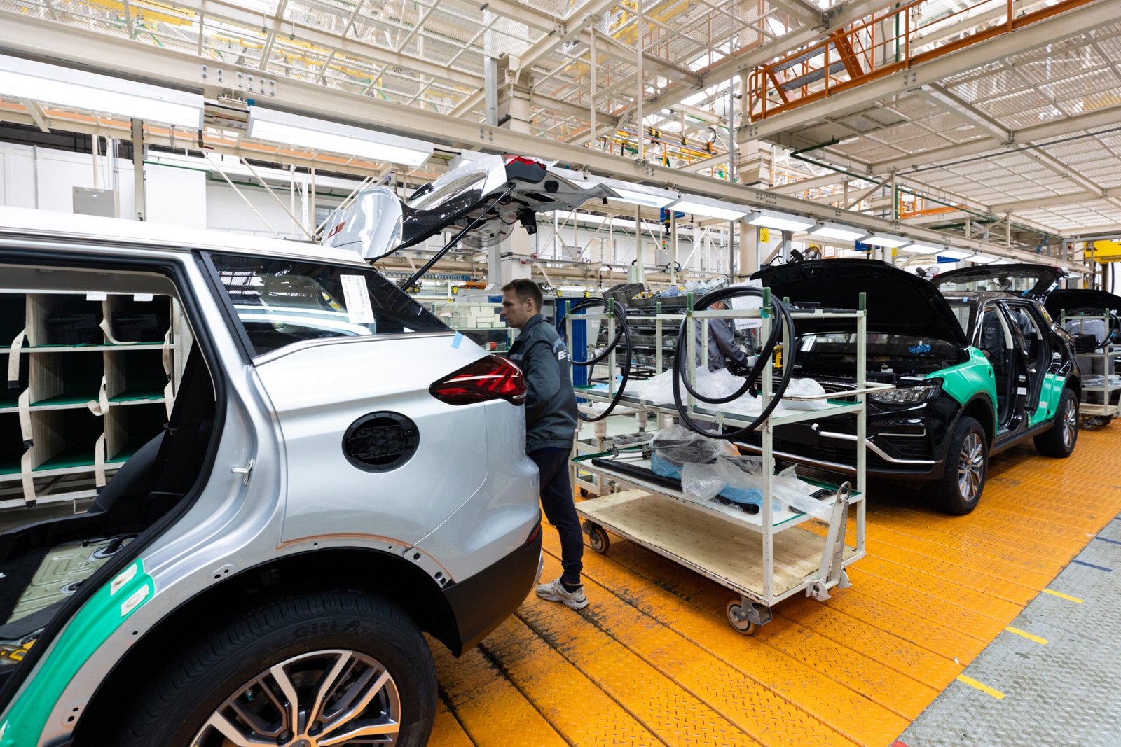Home minsk, belarus dec 15, 2021: car bodies are on assembly line. factory for production of cars. modern automotive industry. electric car factory, conveyor